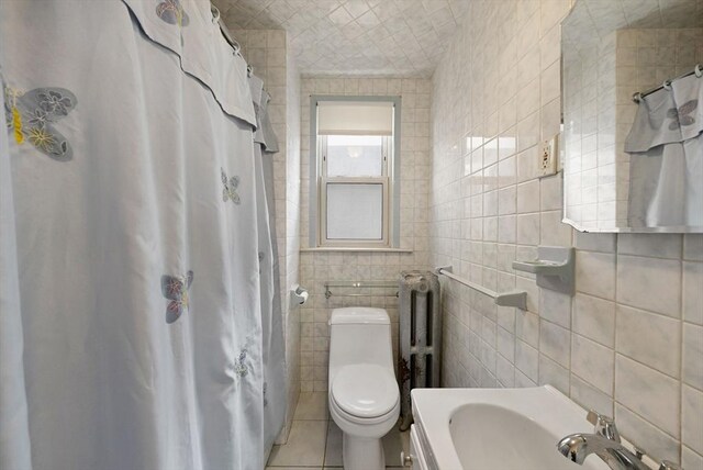 562 Broadway, Everett, MA 02149 - full bath with tile walls, tile patterned floors, and a shower with shower curtain