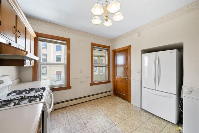 562 Broadway, Everett, MA 02149 - kitchen with white appliances, washer / dryer, baseboard heating, a chandelier, and wainscoting