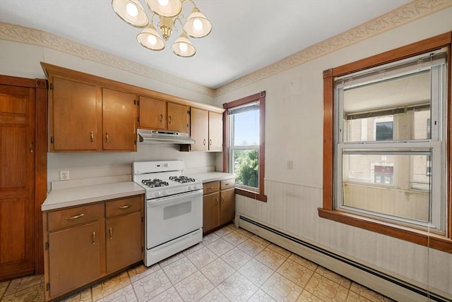 562 Broadway, Everett, MA 02149 - kitchen with white range with gas stovetop, a baseboard heating unit, under cabinet range hood, light countertops, and a chandelier
