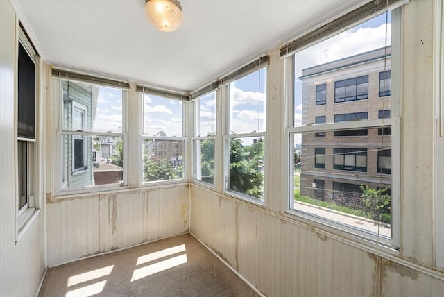 562 Broadway, Everett, MA 02149 - unfurnished sunroom featuring wood walls and carpet