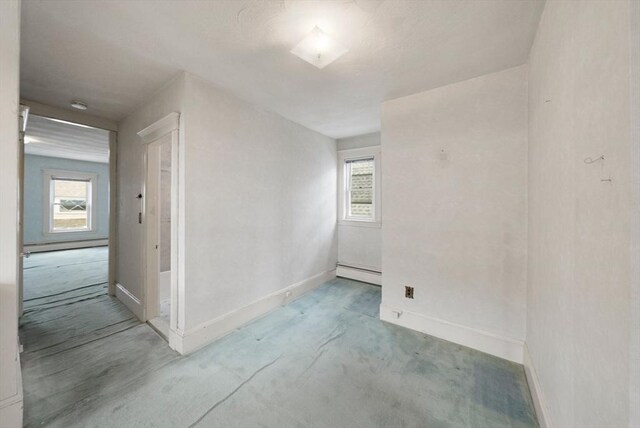 562 Broadway, Everett, MA 02149 - empty room featuring baseboard heating, plenty of natural light, and a baseboard radiator