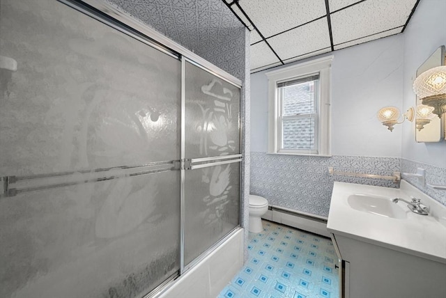 562 Broadway, Everett, MA 02149 - bathroom with a baseboard radiator, vanity, tile walls, shower / bath combination with glass door, and tile patterned floors