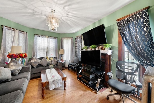 562 Broadway, Everett, MA 02149 - living area featuring healthy amount of natural light, wood finished floors, and a chandelier