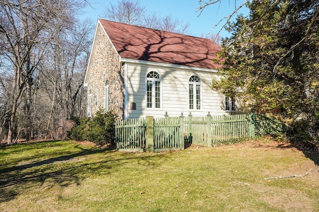 view of home's exterior with a lawn