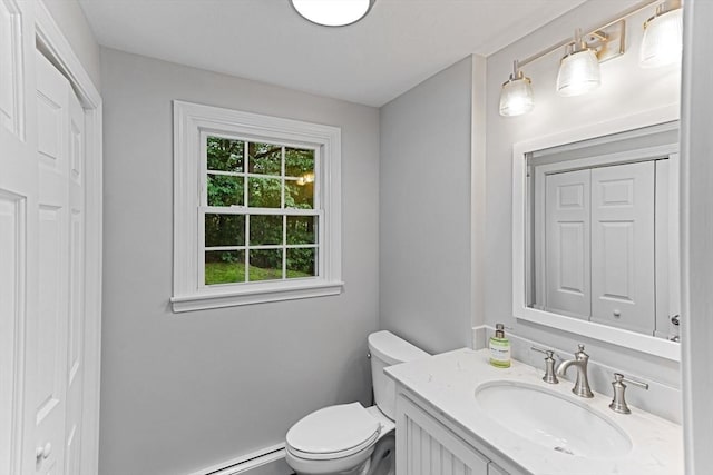 300 Maple St, Franklin, MA 02038 - bathroom featuring toilet, vanity, a baseboard heating unit, and a closet
