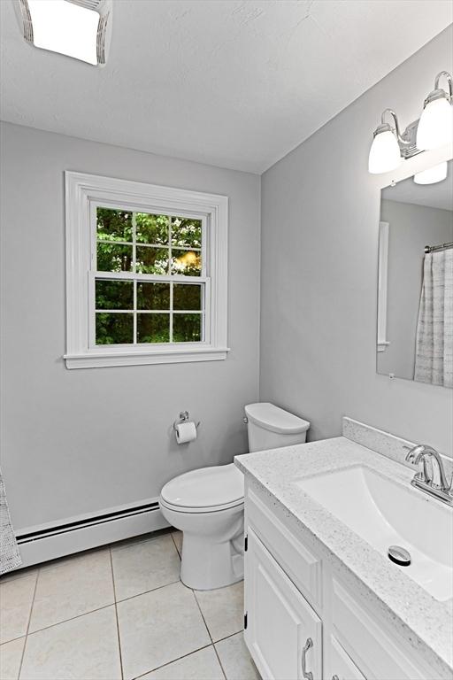 300 Maple St, Franklin, MA 02038 - bathroom featuring a baseboard heating unit, vanity, tile patterned flooring, toilet, and a shower with shower curtain