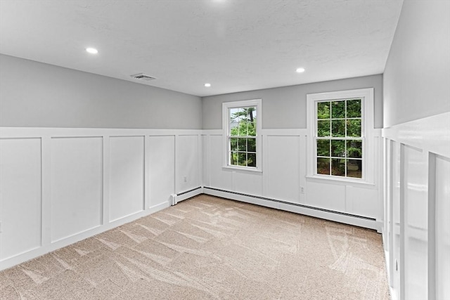 300 Maple St, Franklin, MA 02038 - carpeted empty room with a decorative wall, a baseboard heating unit, wainscoting, and recessed lighting