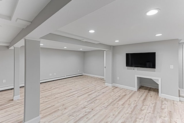 300 Maple St, Franklin, MA 02038 - finished below grade area featuring wood finished floors, recessed lighting, baseboards, and a baseboard heating unit