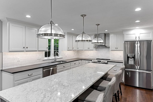300 Maple St, Franklin, MA 02038 - kitchen with appliances with stainless steel finishes, wall chimney exhaust hood, a sink, a kitchen island, and white cabinetry