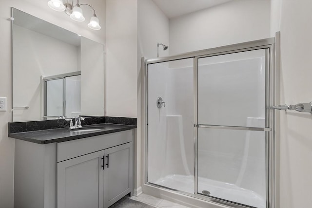 bathroom with tile patterned floors, vanity, and a shower with shower door