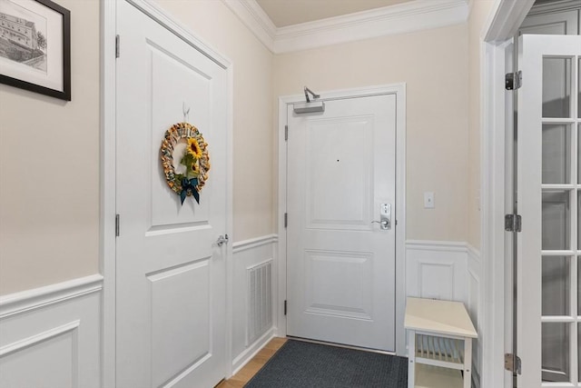 doorway to outside featuring wood-type flooring and ornamental molding