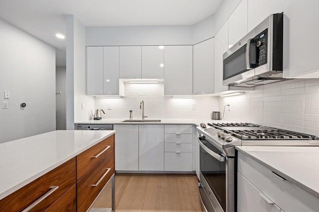 7 Lisbon St Unit 201, Boston, MA 02128 - kitchen with stainless steel appliances, modern cabinets, light countertops, white cabinetry, and recessed lighting