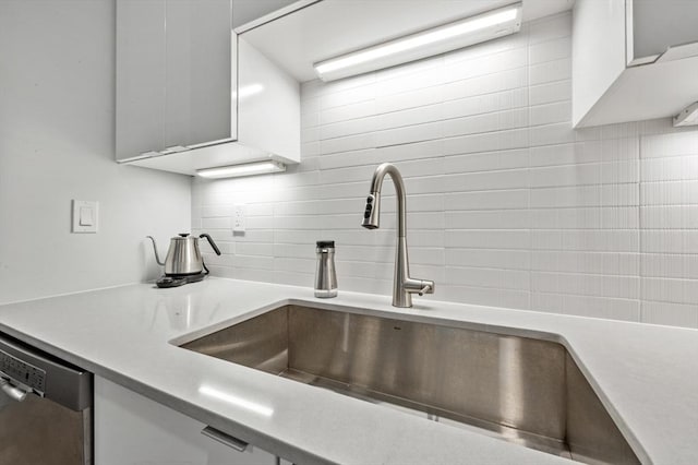 7 Lisbon St Unit 201, Boston, MA 02128 - kitchen featuring tasteful backsplash, dishwasher, light countertops, and white cabinets