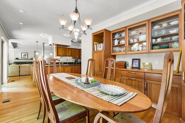 34 Lagrange St, Brookline, MA 02467 - dining area with crown molding, light wood-style floors, a chandelier, and recessed lighting