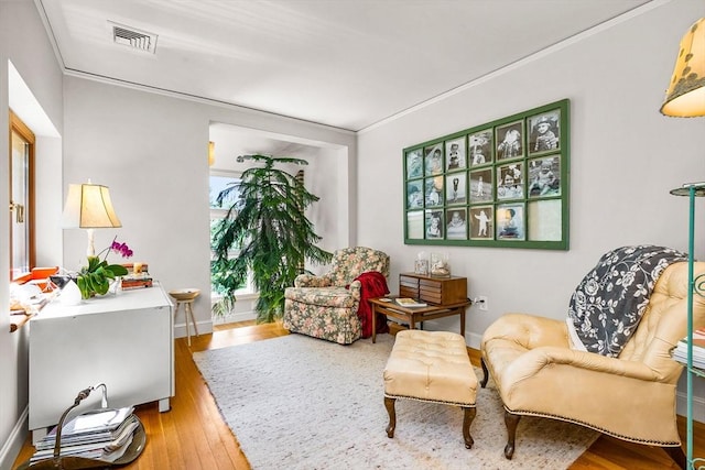 34 Lagrange St, Brookline, MA 02467 - living area featuring wood finished floors and ornamental molding