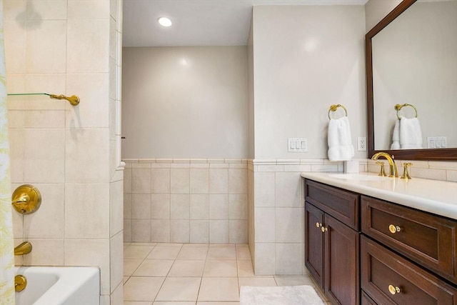 34 Lagrange St, Brookline, MA 02467 - bathroom with tile walls, vanity, tile patterned floors, shower / washtub combination, and a wainscoted wall