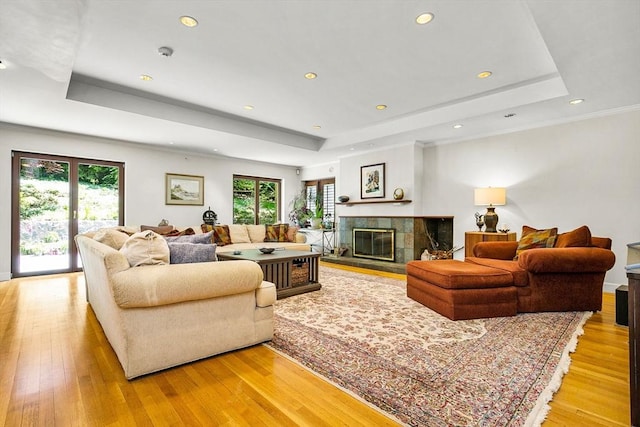 34 Lagrange St, Brookline, MA 02467 - living area with a raised ceiling, light wood-style flooring, a tile fireplace, and recessed lighting