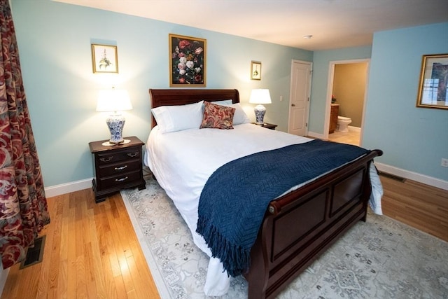 bedroom with visible vents, baseboards, and light wood-type flooring