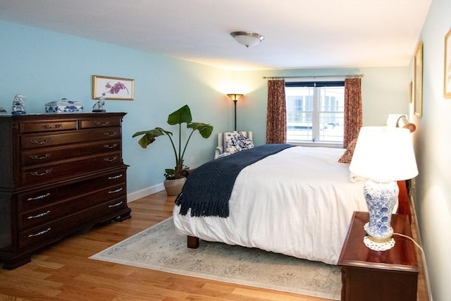 bedroom with baseboards and wood finished floors