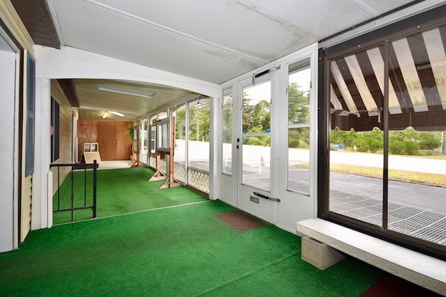 unfurnished sunroom with lofted ceiling