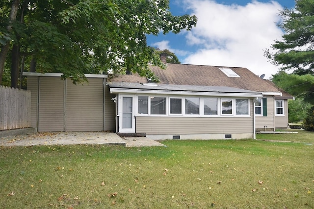 rear view of property featuring a yard