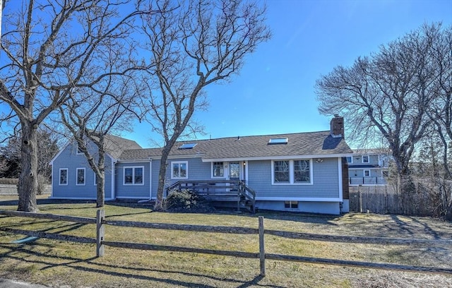10 Chadwell Ave, Sandwich, MA 02563 - view of front of home featuring a front yard, fence, a shingled roof, and a chimney