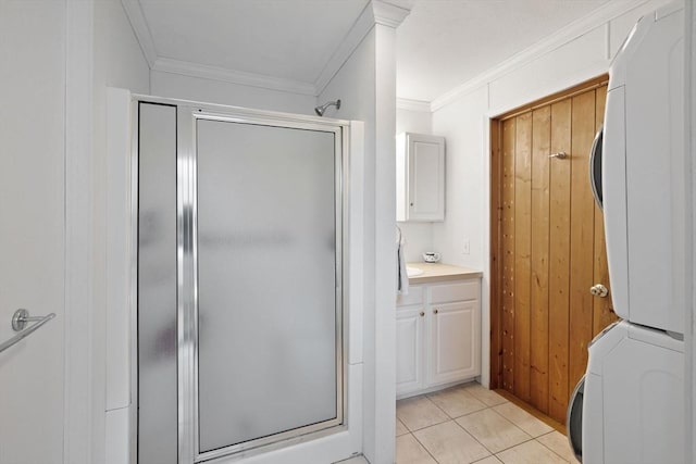 10 Chadwell Ave, Sandwich, MA 02563 - bathroom with a shower stall, tile patterned floors, ornamental molding, and stacked washer / drying machine