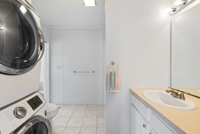 10 Chadwell Ave, Sandwich, MA 02563 - washroom featuring laundry area, light tile patterned floors, stacked washer and dryer, ornamental molding, and a sink