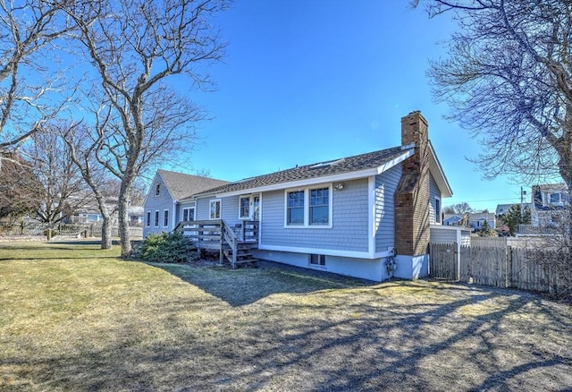 10 Chadwell Ave, Sandwich, MA 02563 - view of front of home with a front yard, fence, and a chimney