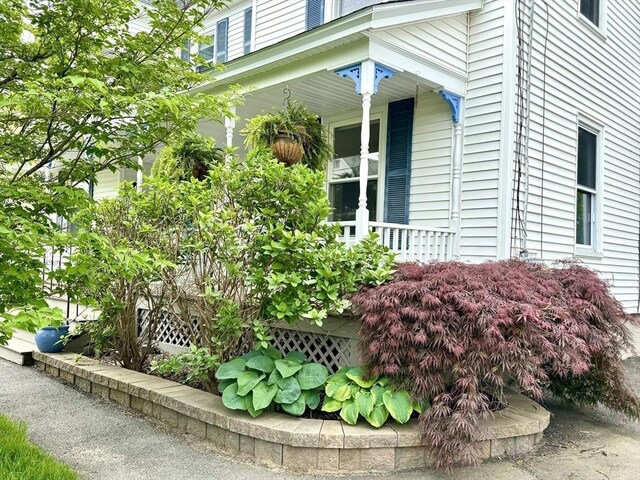 view of property exterior with a porch