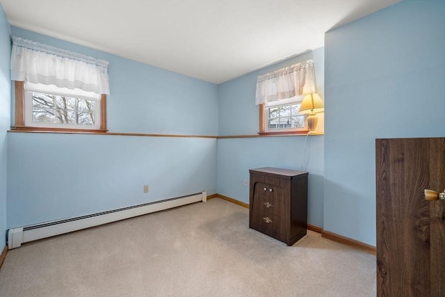 carpeted bedroom with a baseboard radiator and baseboards