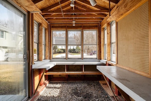 unfurnished sunroom featuring vaulted ceiling