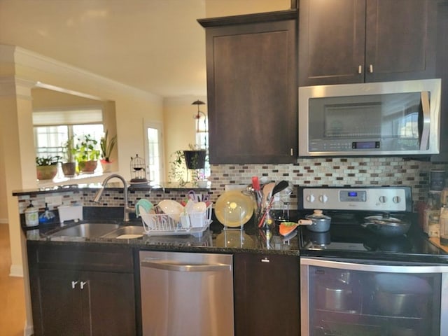 422 John Mahar Hwy Unit 305, Braintree, MA 02184 - kitchen featuring stainless steel appliances, a sink, dark brown cabinetry, and dark stone countertops