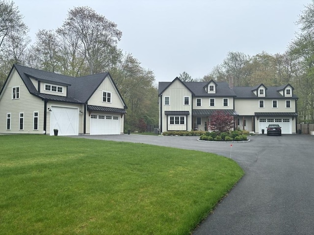 35 E St, Middleton, MA 01949 - view of front of house with a standing seam roof, a metal roof, driveway, and a front lawn