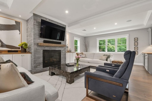 35 E St, Middleton, MA 01949 - living area featuring ornamental molding, a stone fireplace, recessed lighting, a raised ceiling, and light wood-style floors