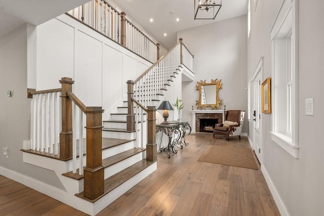 35 E St, Middleton, MA 01949 - foyer with a high ceiling, wood-type flooring, a fireplace, stairway, and recessed lighting
