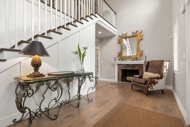 35 E St, Middleton, MA 01949 - foyer entrance with wood finished floors, a brick fireplace, stairs, and a towering ceiling