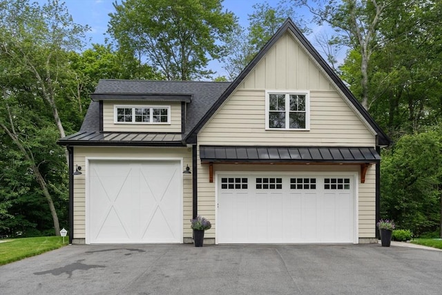 35 E St, Middleton, MA 01949 - view of front of house with a standing seam roof, a metal roof, board and batten siding, asphalt driveway, and roof with shingles