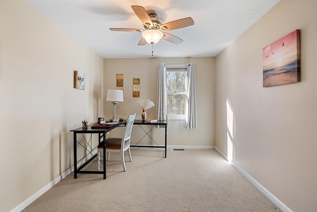 office space with carpet, visible vents, baseboards, and a ceiling fan