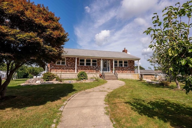 ranch-style home with a porch, brick siding, a chimney, and a front lawn