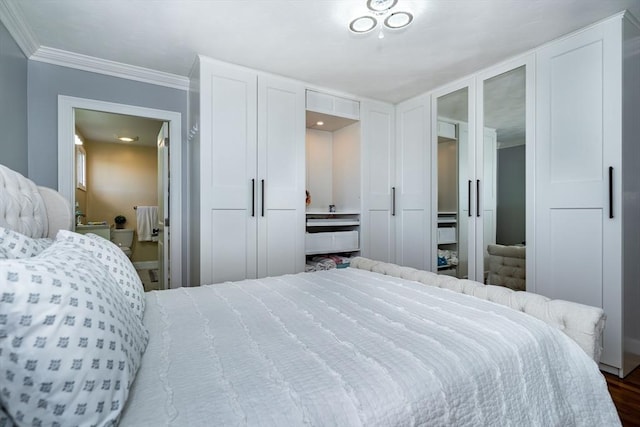 bedroom featuring ornamental molding and dark wood finished floors