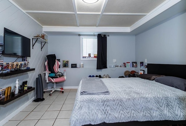 bedroom with light tile patterned floors and baseboards