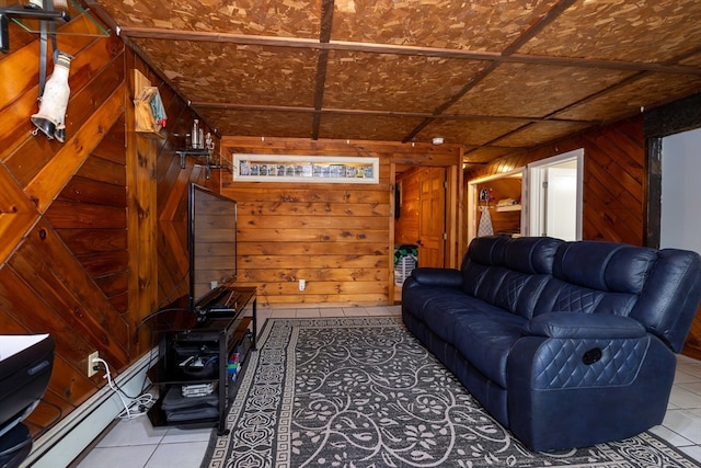 tiled living room featuring a baseboard heating unit and wood walls