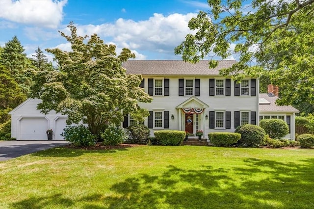 11 Tara Dr, Pembroke, MA 02359 - colonial inspired home featuring a garage, a front yard, asphalt driveway, and a chimney