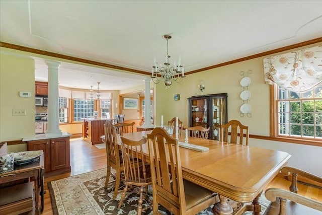 11 Tara Dr, Pembroke, MA 02359 - dining area featuring ornate columns, a chandelier, light wood finished floors, and crown molding