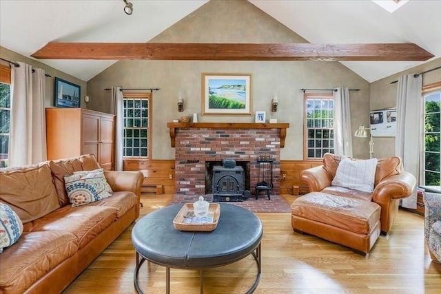 11 Tara Dr, Pembroke, MA 02359 - living room with wood finished floors, a wood stove, wainscoting, and a baseboard heating unit