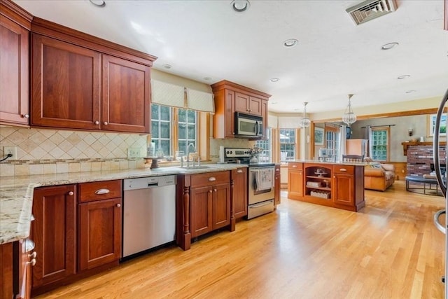 11 Tara Dr, Pembroke, MA 02359 - kitchen with appliances with stainless steel finishes, light wood-type flooring, decorative backsplash, decorative light fixtures, and recessed lighting