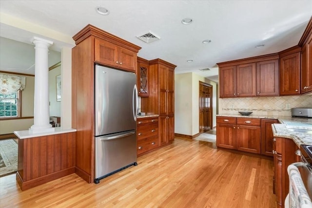 11 Tara Dr, Pembroke, MA 02359 - kitchen featuring freestanding refrigerator, decorative columns, brown cabinetry, backsplash, and recessed lighting