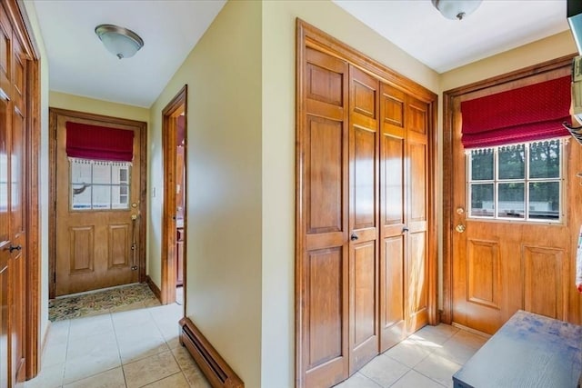 11 Tara Dr, Pembroke, MA 02359 - doorway to outside featuring light tile patterned floors and a baseboard heating unit