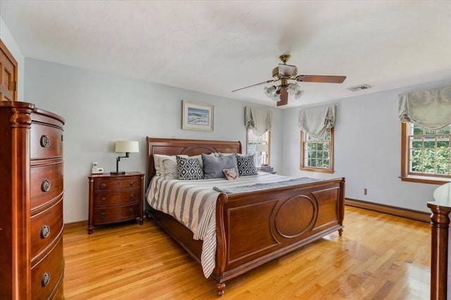 11 Tara Dr, Pembroke, MA 02359 - bedroom with multiple windows, a baseboard heating unit, light wood-style floors, and ceiling fan